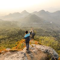 Photo of Man Standing on Rock Pointing Out Mountain-CC0-Silitonga-Pexels.jpg